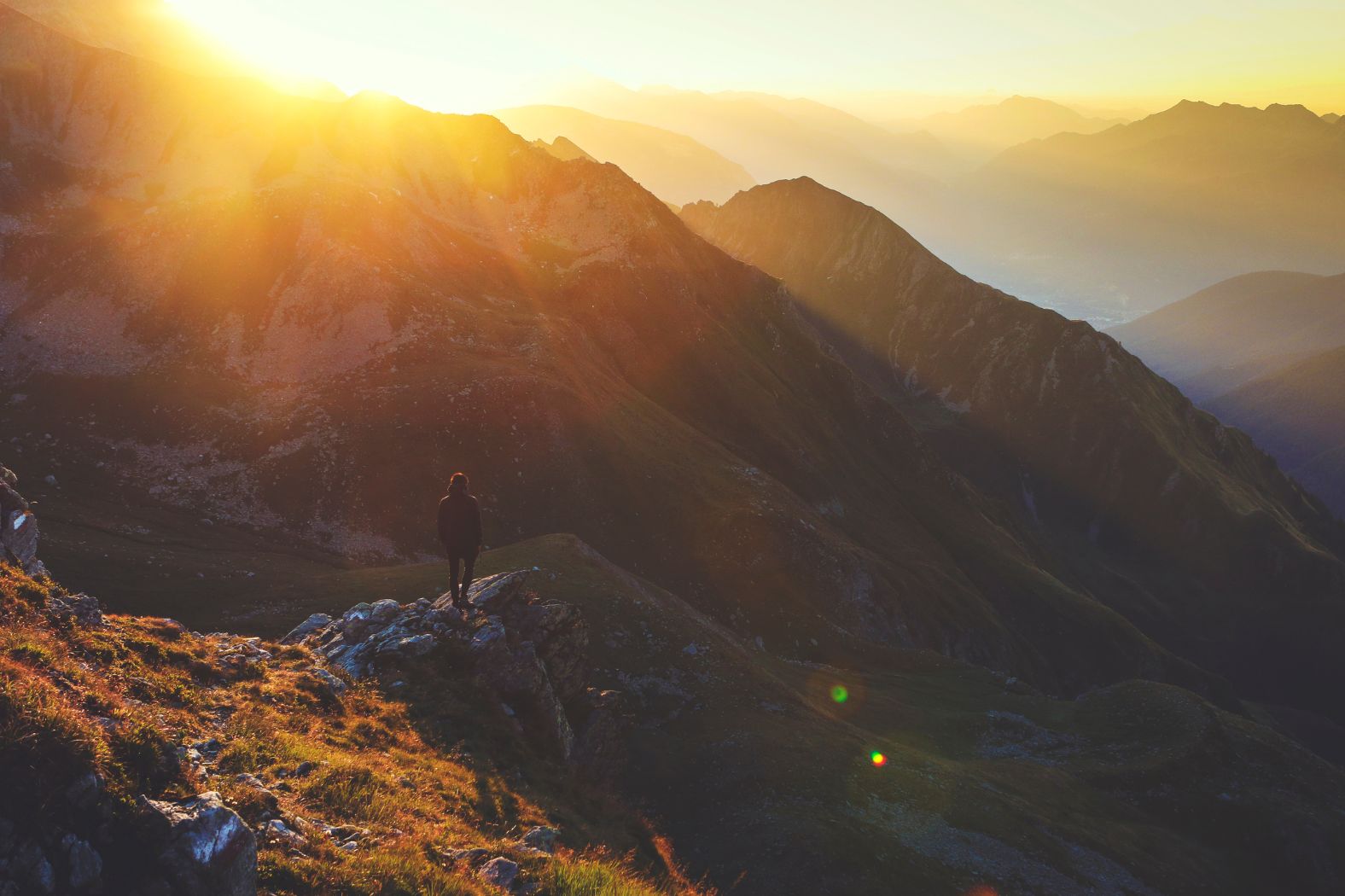 Woman standing in the middle of the mountains