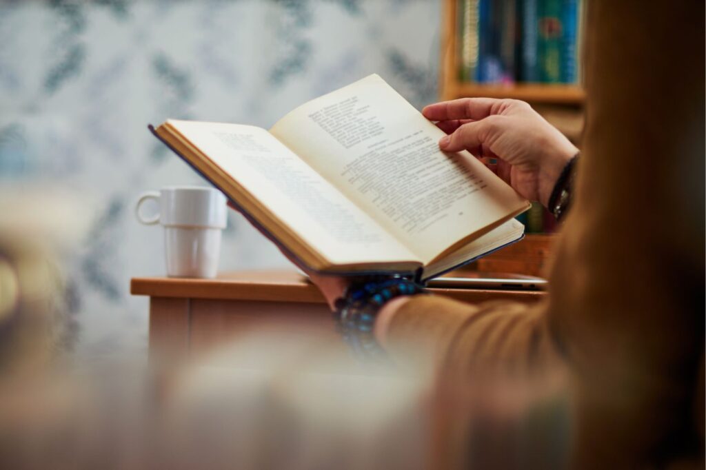 Woman reading a book at her desk